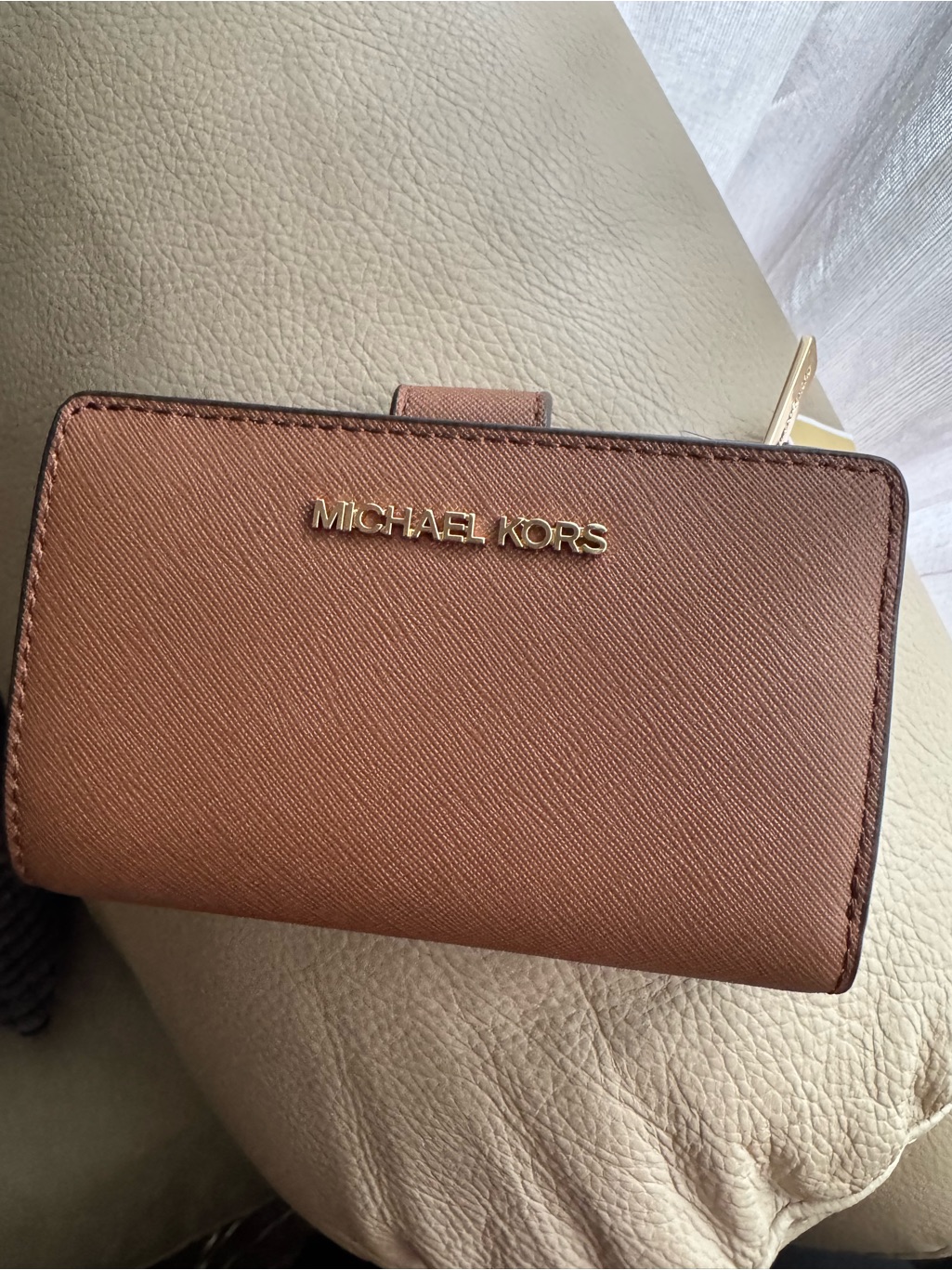 Michael Kors Light Brown Saffiano Leather Compact Wallet With Gold Logo.
